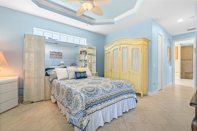 tiled bedroom with a raised ceiling, ceiling fan, and ornamental molding