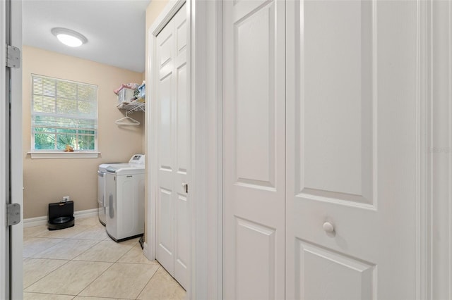 laundry room featuring light tile patterned floors and washer and dryer