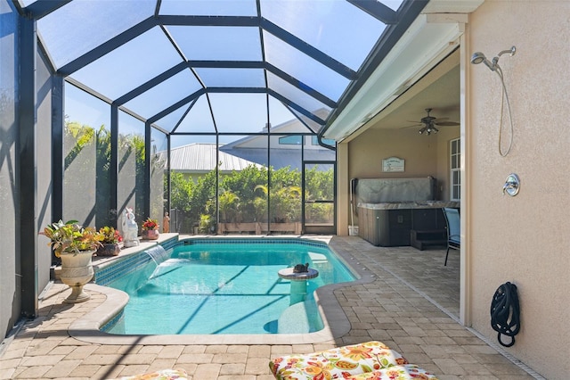 view of pool with pool water feature, a patio area, ceiling fan, and a lanai