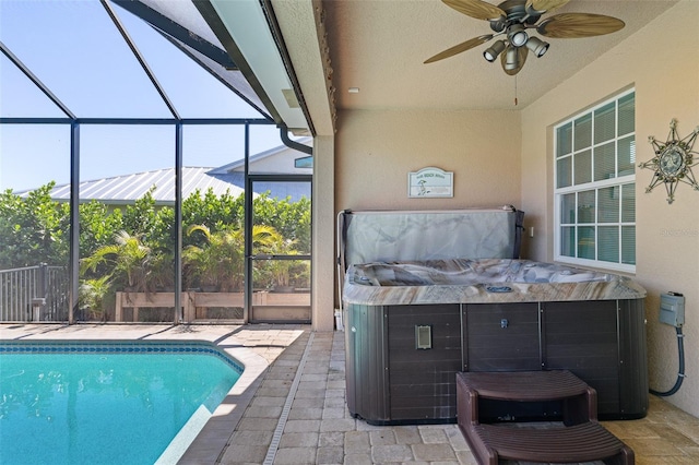 view of pool with a patio, a hot tub, glass enclosure, and ceiling fan