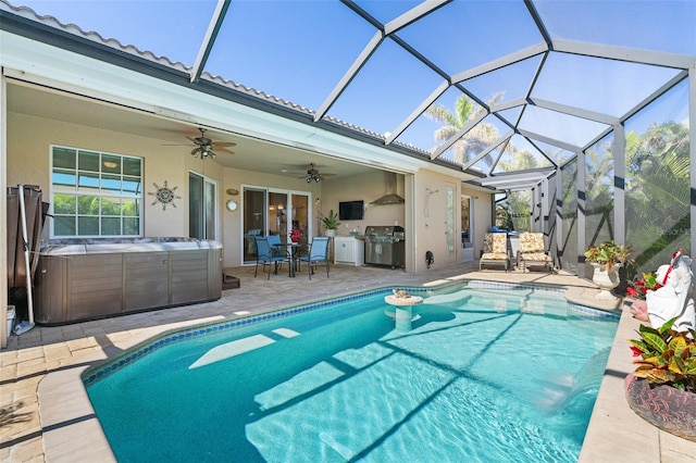 view of pool featuring glass enclosure, ceiling fan, area for grilling, a patio, and a hot tub