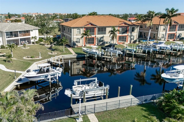 dock area featuring a lawn and a water view