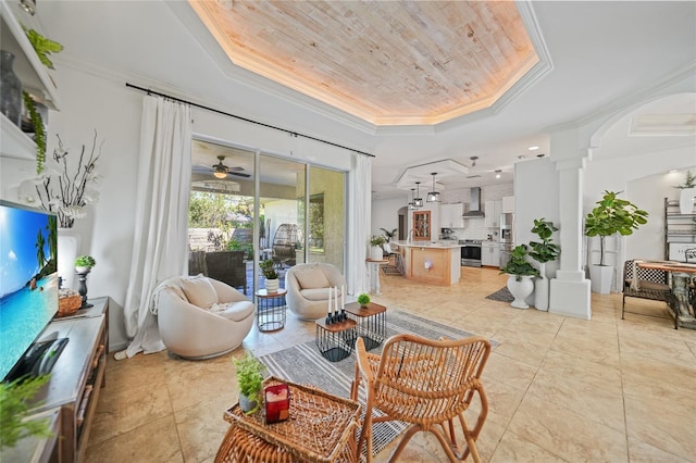 17080 Kellog Ave, Port Charlotte, FL 33954 - living room featuring a tray ceiling, ornate columns, ornamental molding, wooden ceiling, and light tile patterned floors