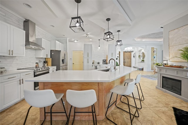 17080 Kellog Ave, Port Charlotte, FL 33954 - kitchen with wall chimney exhaust hood, stainless steel appliances, a sink, backsplash, and a kitchen bar