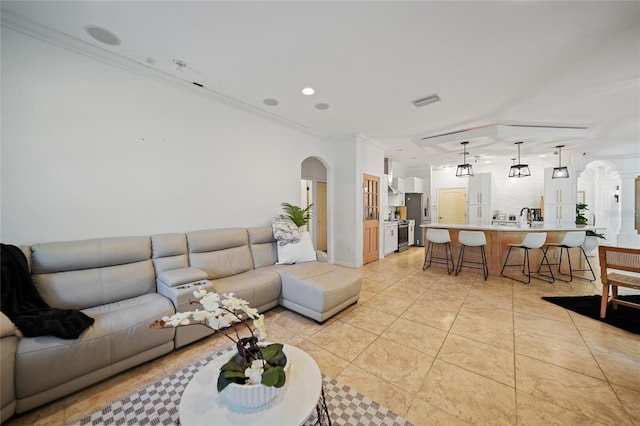 17080 Kellog Ave, Port Charlotte, FL 33954 - living room with arched walkways, ornamental molding, light tile patterned floors, and recessed lighting