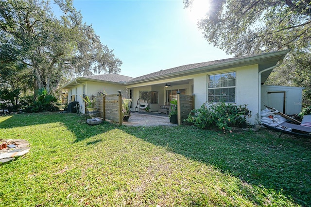 17080 Kellog Ave, Port Charlotte, FL 33954 - back of house featuring a ceiling fan, stucco siding, a lawn, and a patio