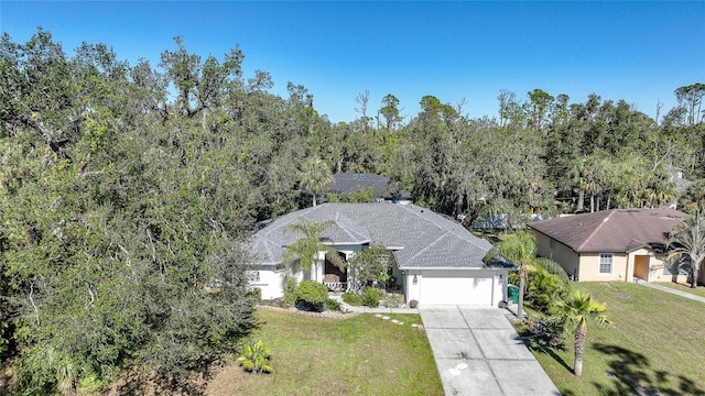17080 Kellog Ave, Port Charlotte, FL 33954 - view of front of house featuring driveway, an attached garage, and a front lawn