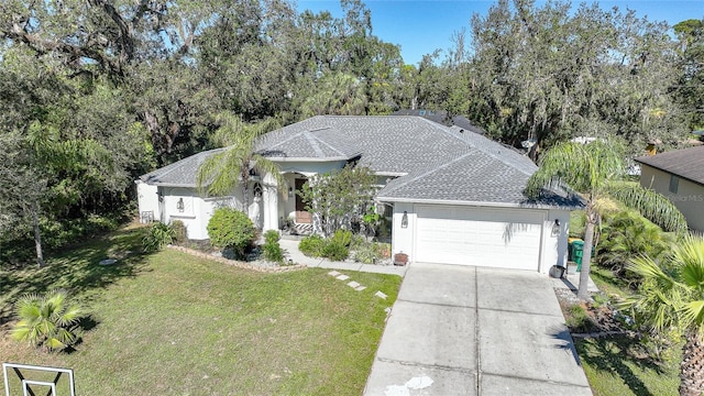 17080 Kellog Ave, Port Charlotte, FL 33954 - single story home featuring a garage, a front yard, roof with shingles, driveway, and stucco siding