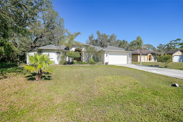 17080 Kellog Ave, Port Charlotte, FL 33954 - view of front of home featuring driveway, a garage, a front lawn, and stucco siding
