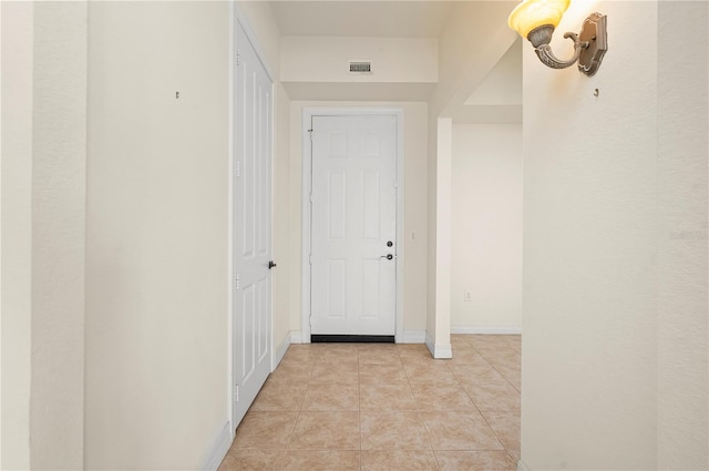 hallway featuring light tile patterned floors