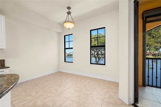 unfurnished dining area featuring light tile patterned flooring