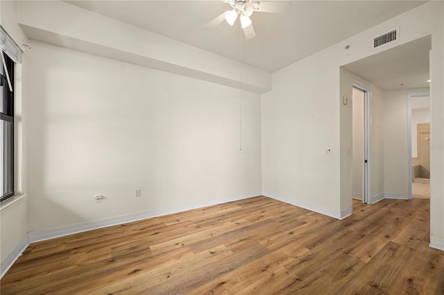 spare room with ceiling fan and light hardwood / wood-style floors