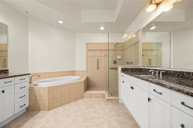 bathroom featuring tile patterned flooring, vanity, and shower with separate bathtub