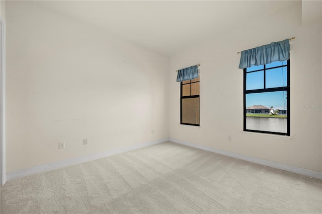 unfurnished room with light colored carpet