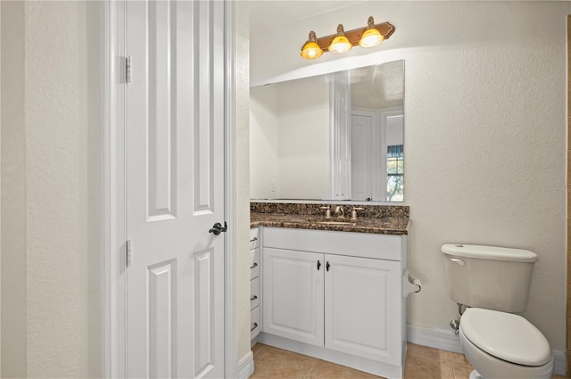 bathroom featuring toilet, vanity, and tile patterned floors