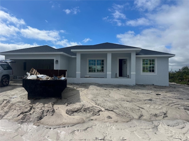 view of front of property with a garage and roof with shingles