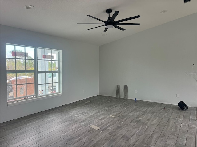 empty room featuring wood finished floors and a ceiling fan