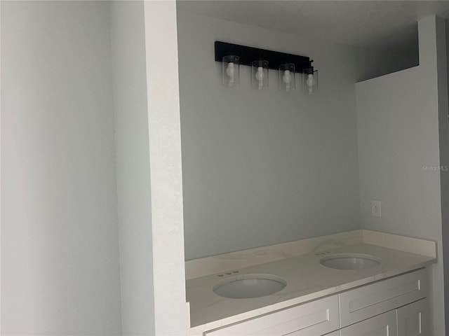 bathroom featuring double vanity and a sink