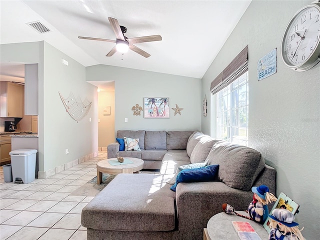 living room featuring light tile patterned floors, vaulted ceiling, and ceiling fan