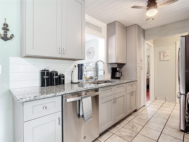 kitchen featuring gray cabinetry, sink, light tile patterned floors, and stainless steel appliances