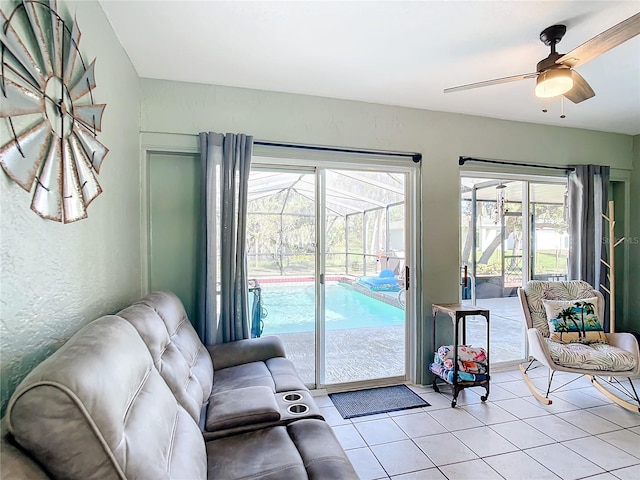 living room featuring light tile patterned floors and ceiling fan