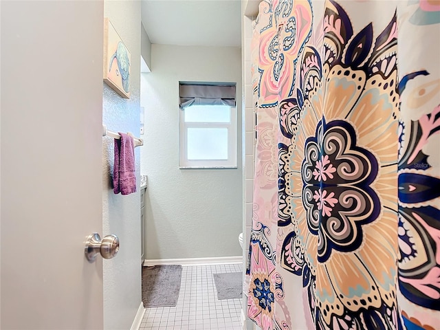 bathroom featuring walk in shower and tile patterned flooring