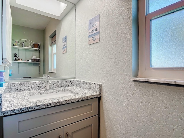 bathroom with vanity and a skylight