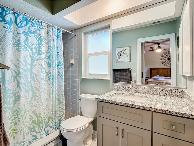 bathroom featuring toilet, vanity, and walk in shower