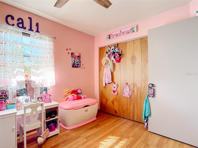 game room with hardwood / wood-style floors and ceiling fan