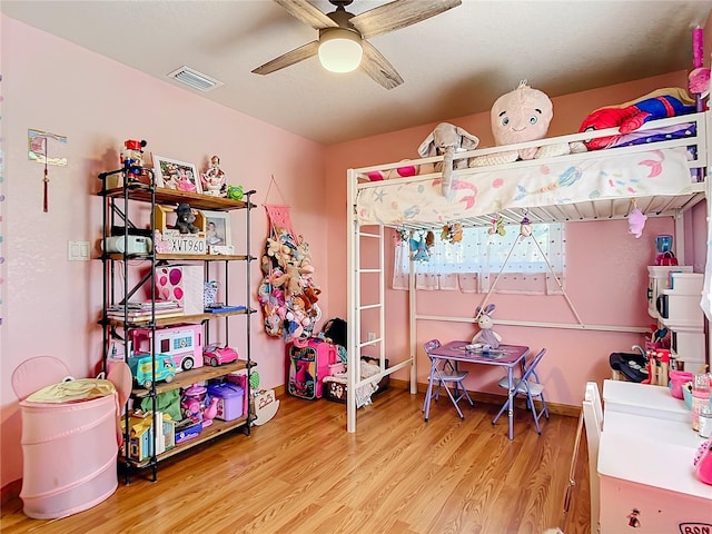 bedroom featuring hardwood / wood-style floors and ceiling fan