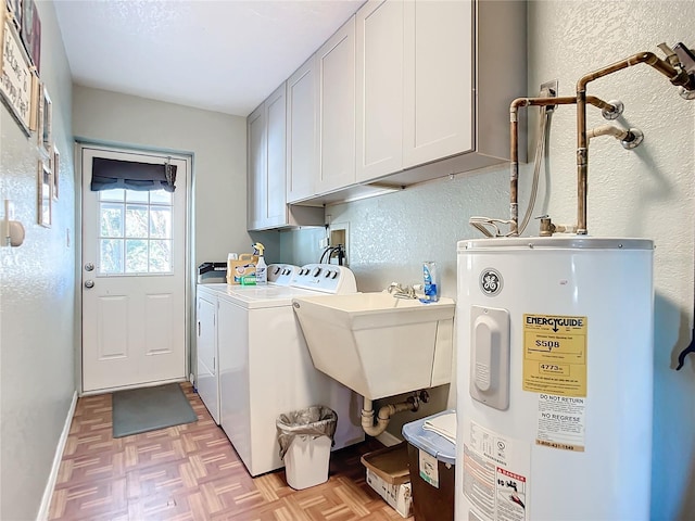 washroom with sink, cabinets, washer and dryer, light parquet flooring, and water heater