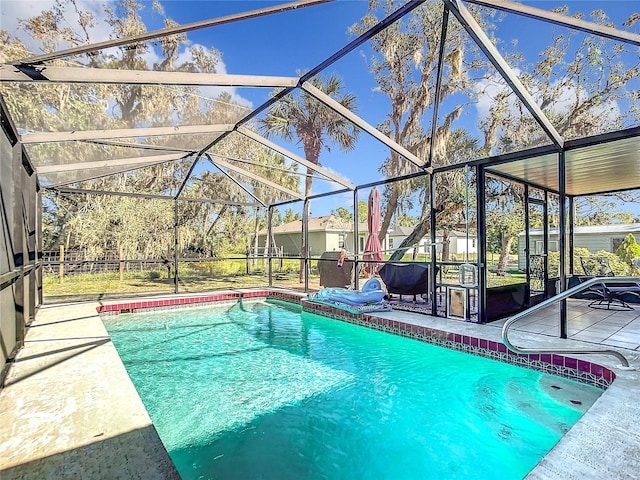 view of pool with a lanai and a patio area