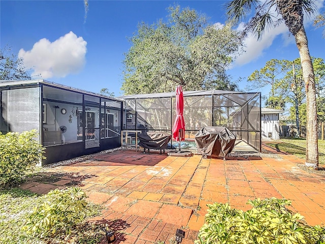 view of patio / terrace featuring glass enclosure