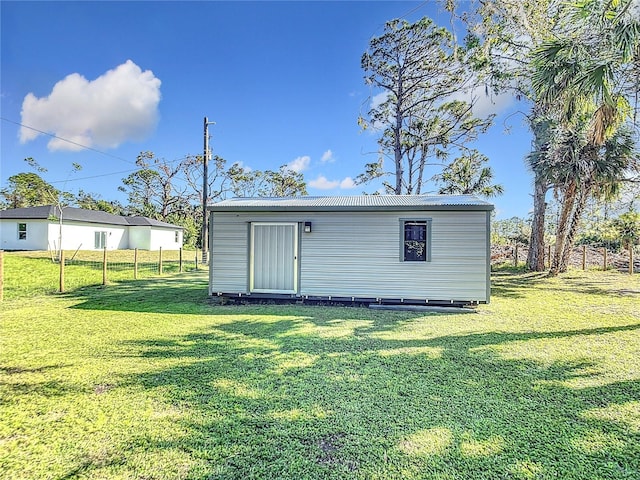 view of outbuilding with a yard