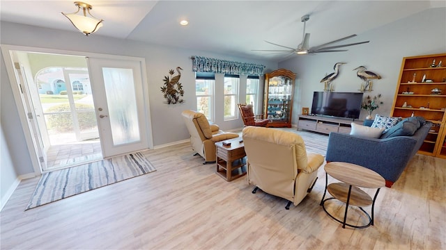 living room with ceiling fan, light hardwood / wood-style flooring, a healthy amount of sunlight, and french doors