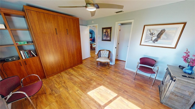 sitting room featuring ceiling fan and light hardwood / wood-style flooring