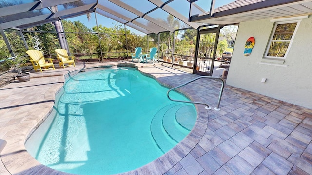 view of swimming pool featuring a lanai and a patio area