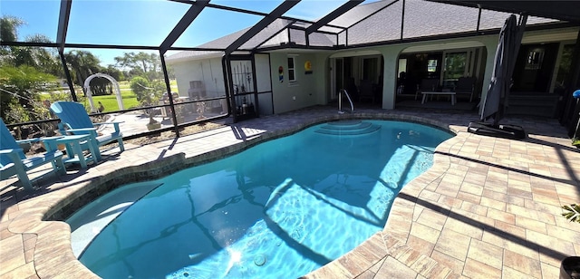 view of swimming pool with a lanai and a patio area