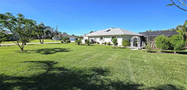 view of yard featuring glass enclosure