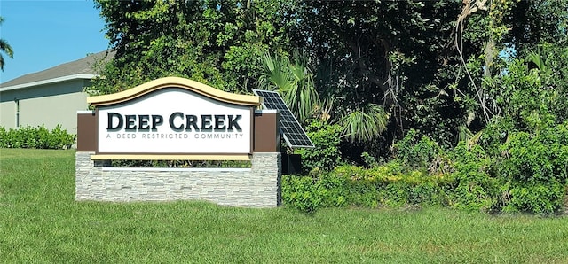 community / neighborhood sign with a lawn