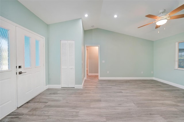 entrance foyer featuring ceiling fan, light hardwood / wood-style flooring, and vaulted ceiling