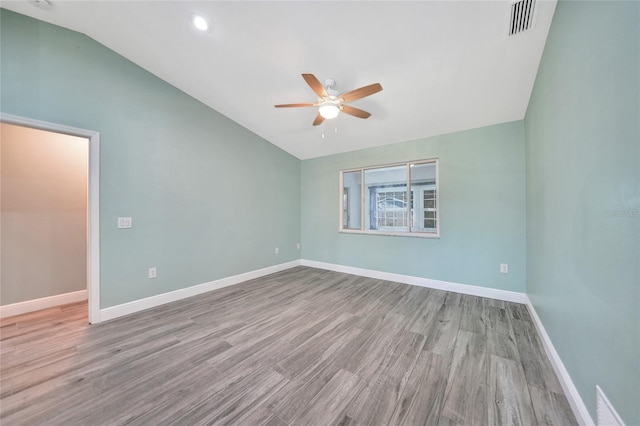 unfurnished room with ceiling fan, vaulted ceiling, and light hardwood / wood-style flooring