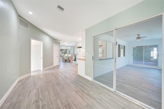 unfurnished room with ceiling fan and light hardwood / wood-style flooring