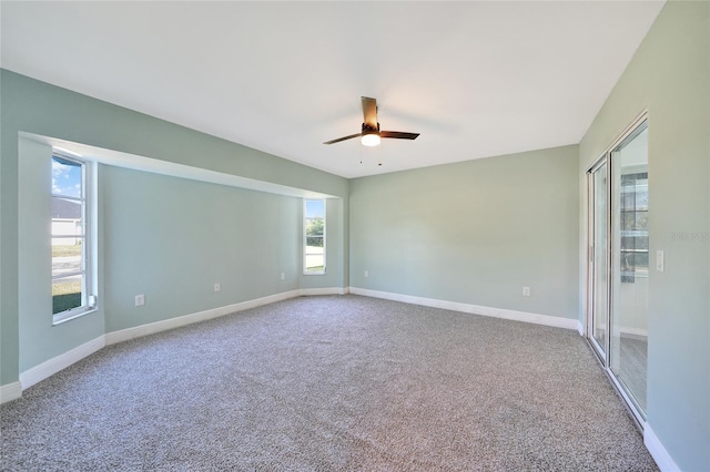 empty room with carpet flooring and ceiling fan