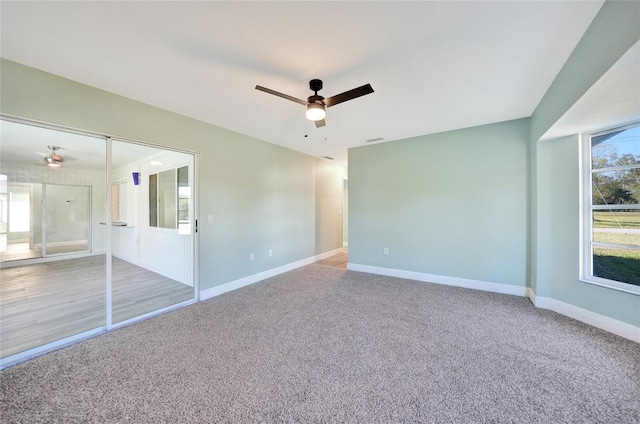 carpeted empty room featuring ceiling fan