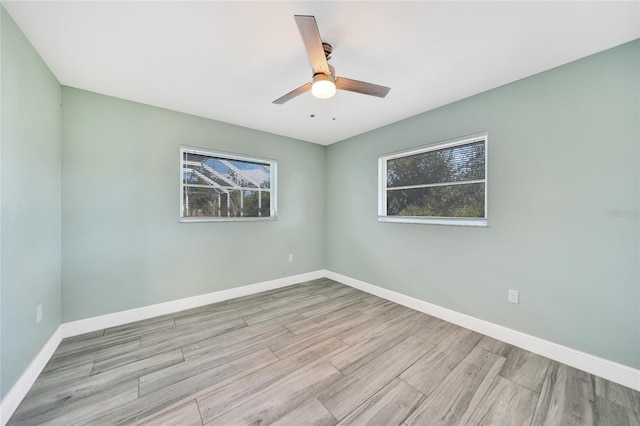 empty room featuring light wood-type flooring and ceiling fan