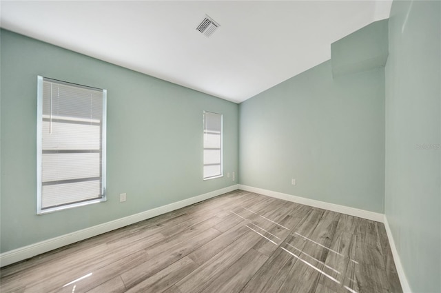 spare room with light hardwood / wood-style flooring