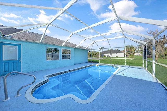 view of swimming pool with a lawn and a lanai