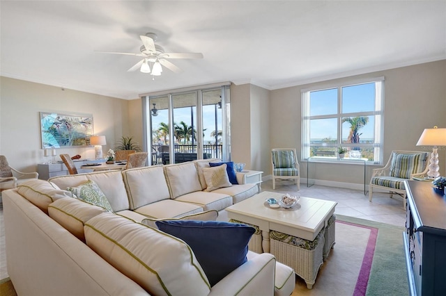 living room featuring ceiling fan, light tile patterned floors, and ornamental molding