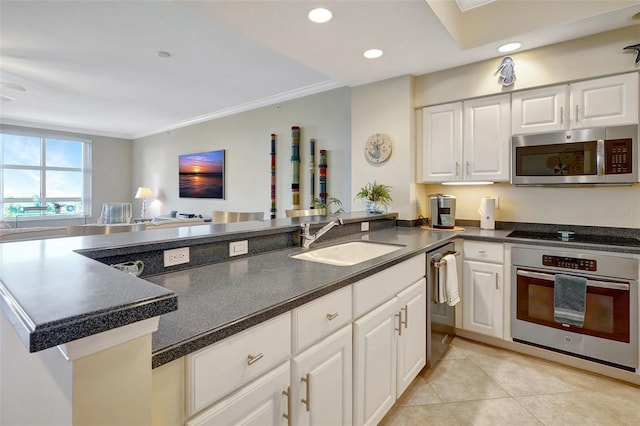 kitchen featuring white cabinets, crown molding, sink, light tile patterned flooring, and stainless steel appliances